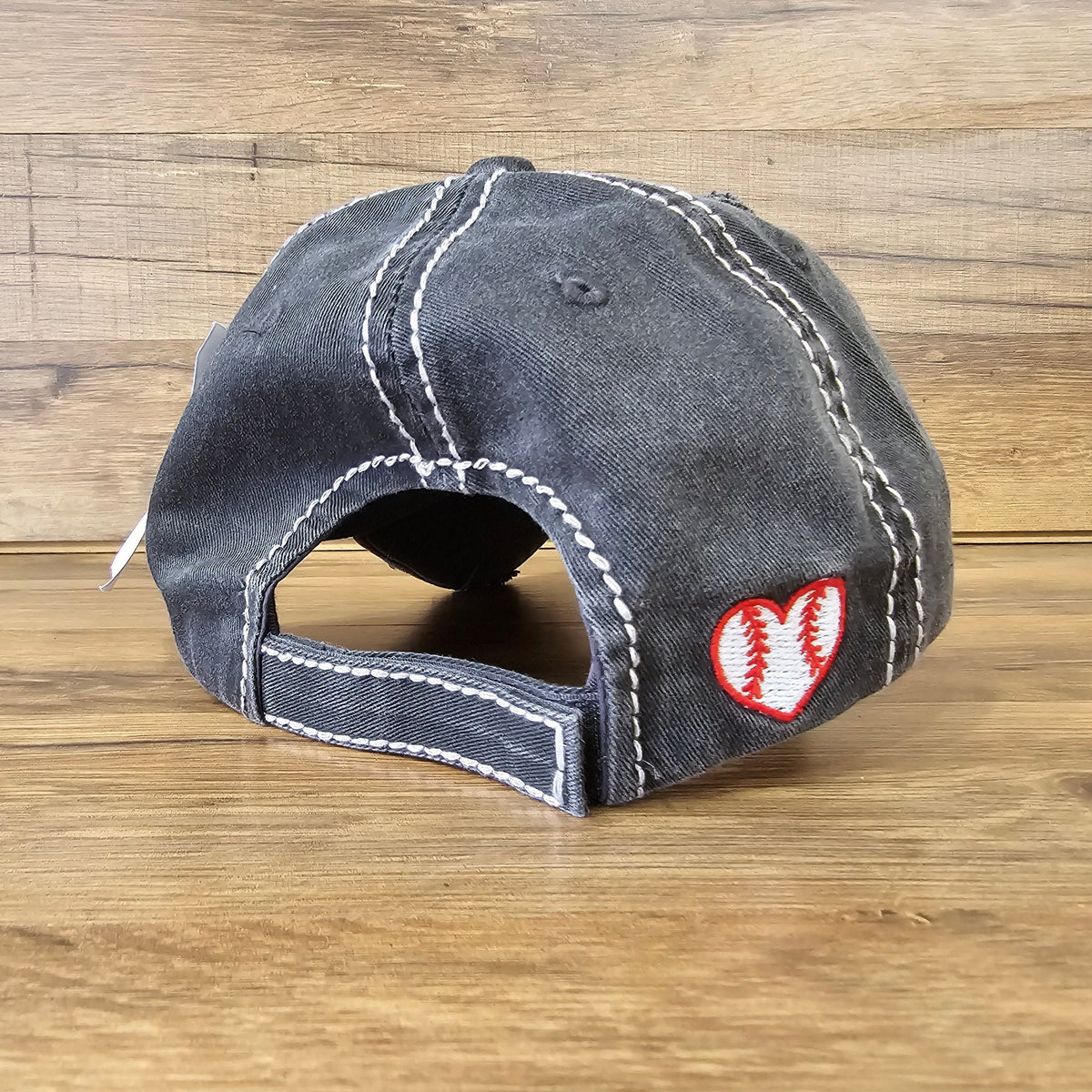 Allen's Bootery distressed black baseball cap with a white stitched heart and baseball seam embroidery on the back.