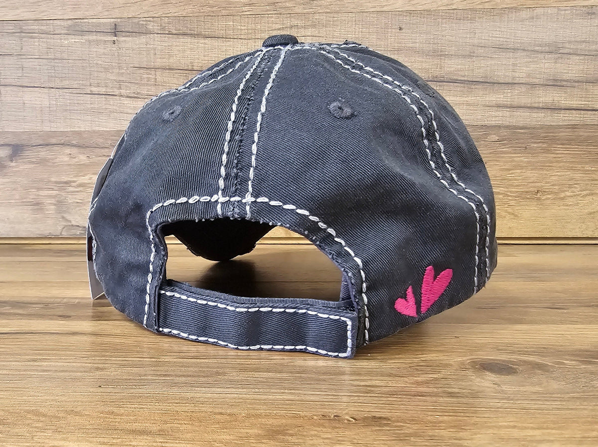 Allen's Bootery black distressed baseball cap with white contrast stitching and pink heart embroidery on the back