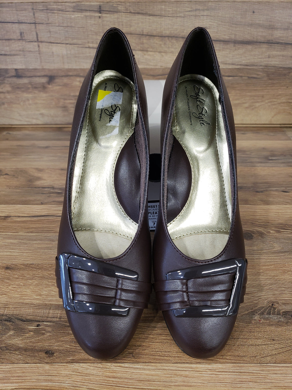 Allen's Bootery dark brown closed-toe pumps with pleated toe detail, buckle ornament, and memory foam footbed.