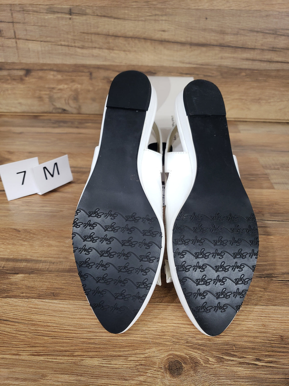 Allen's Bootery Soft Style by Hush Puppies Deni white patent slingback flats showing black textured outsoles