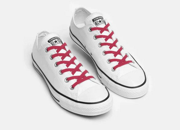 Allen's Bootery Xpand Laces Original in raspberry red installed on white low-top sneakers