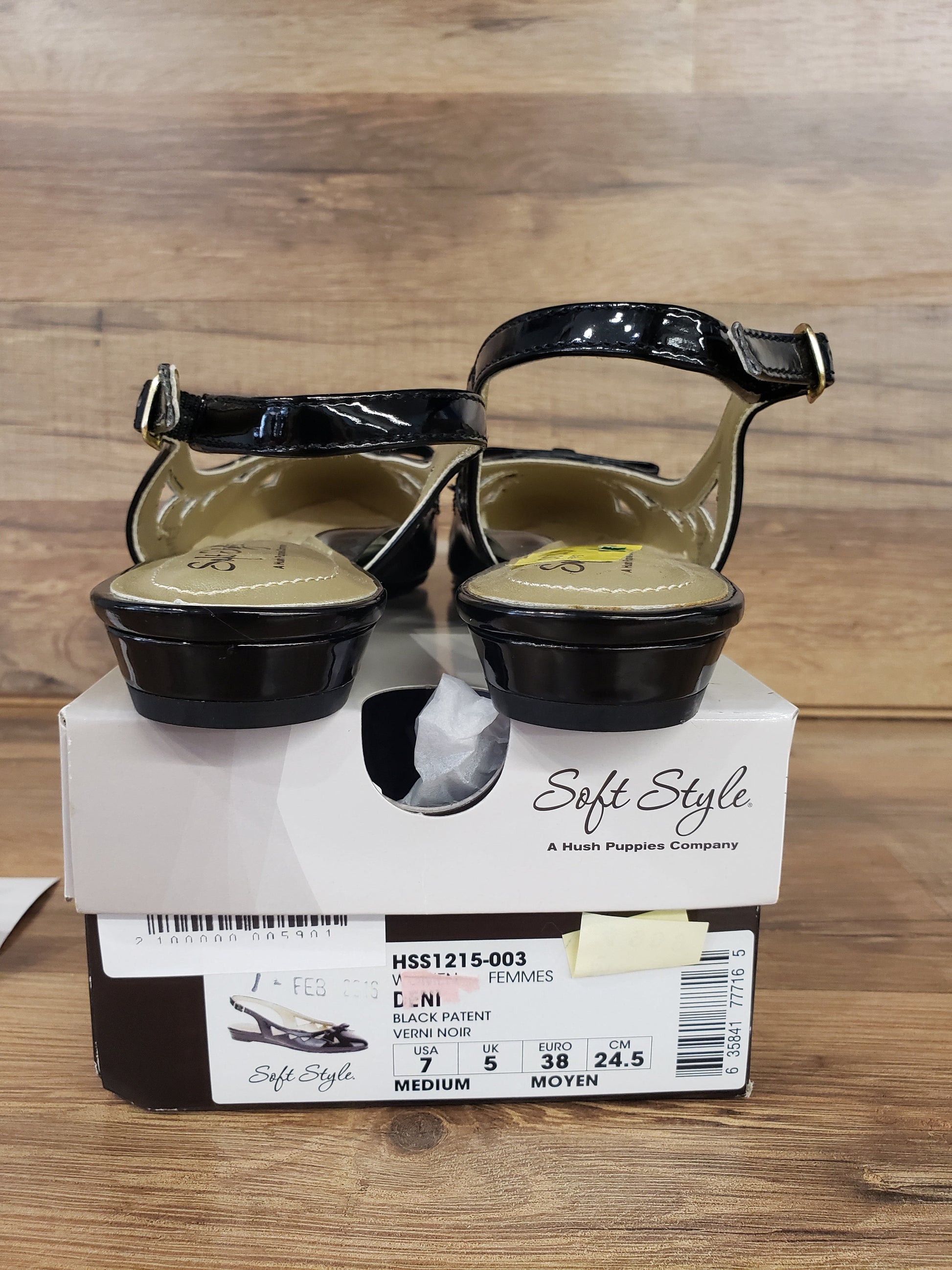 Allen's Bootery black patent leather flat dress shoes with buckle closure, shown from the back on a shoe box.