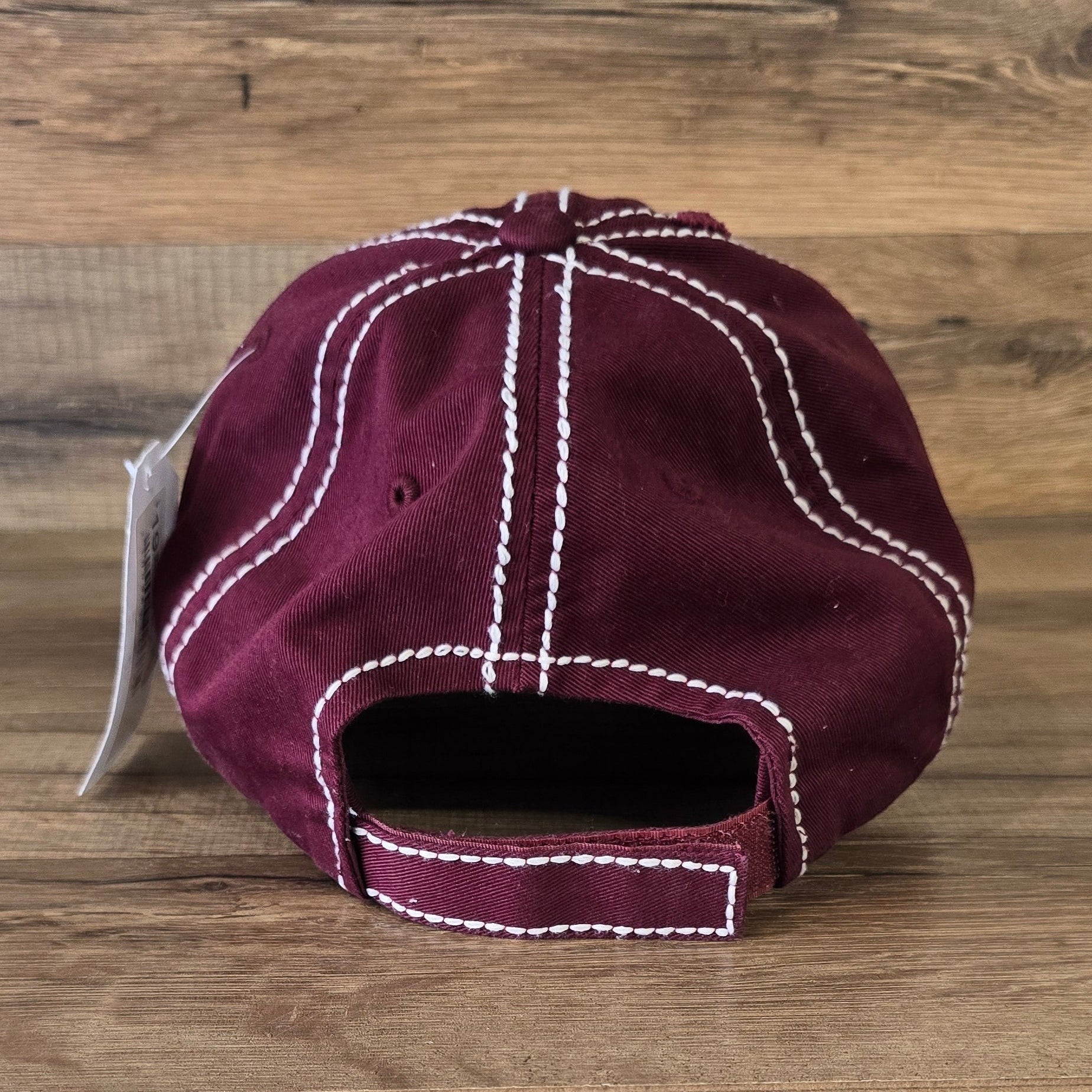 Allen's Bootery deep burgundy distressed cotton baseball cap with white contrast stitching, back view.