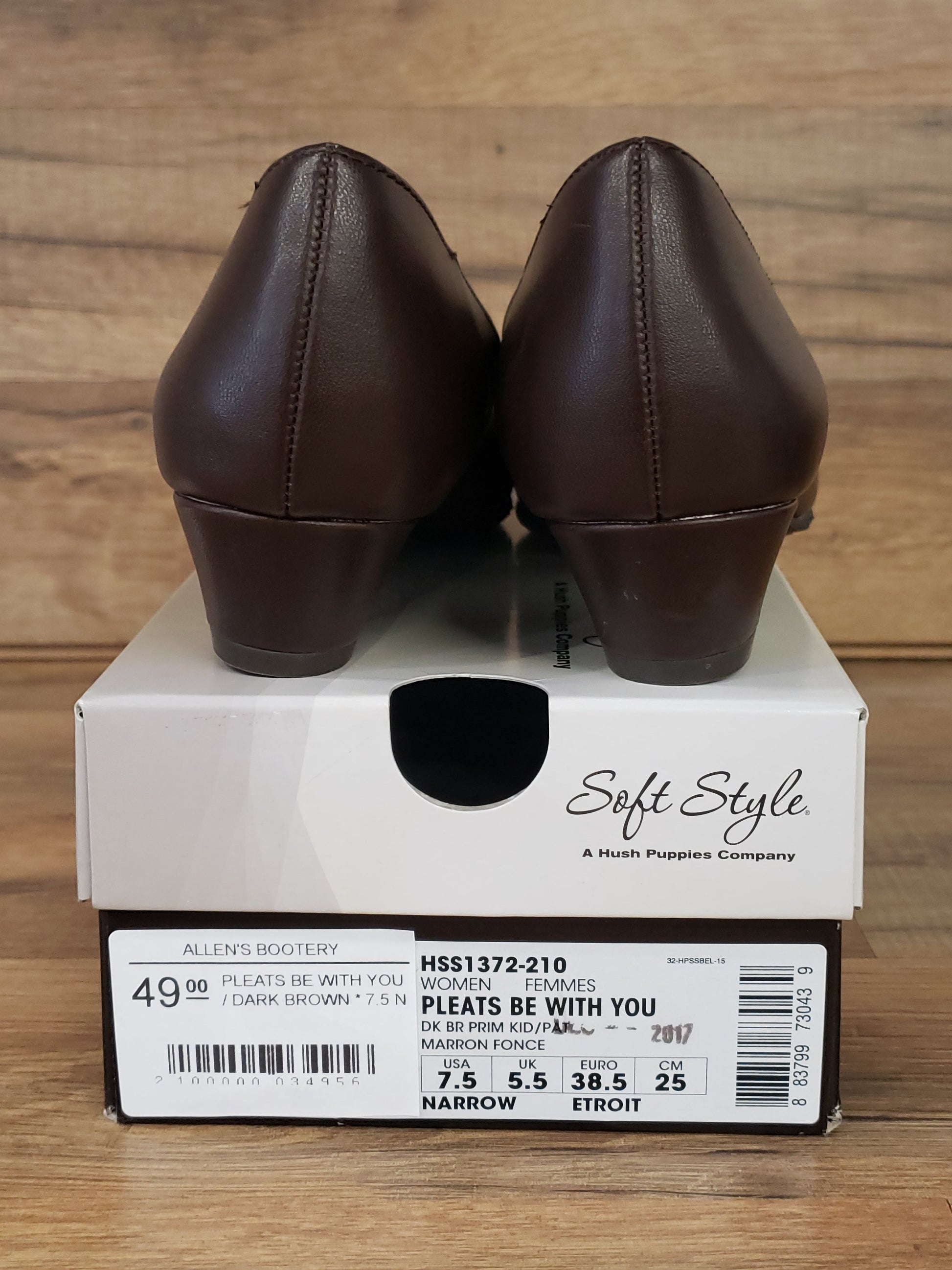 Allen's Bootery dark brown Pleats Be With You pumps showing the back view and low heels resting on their shoe box.
