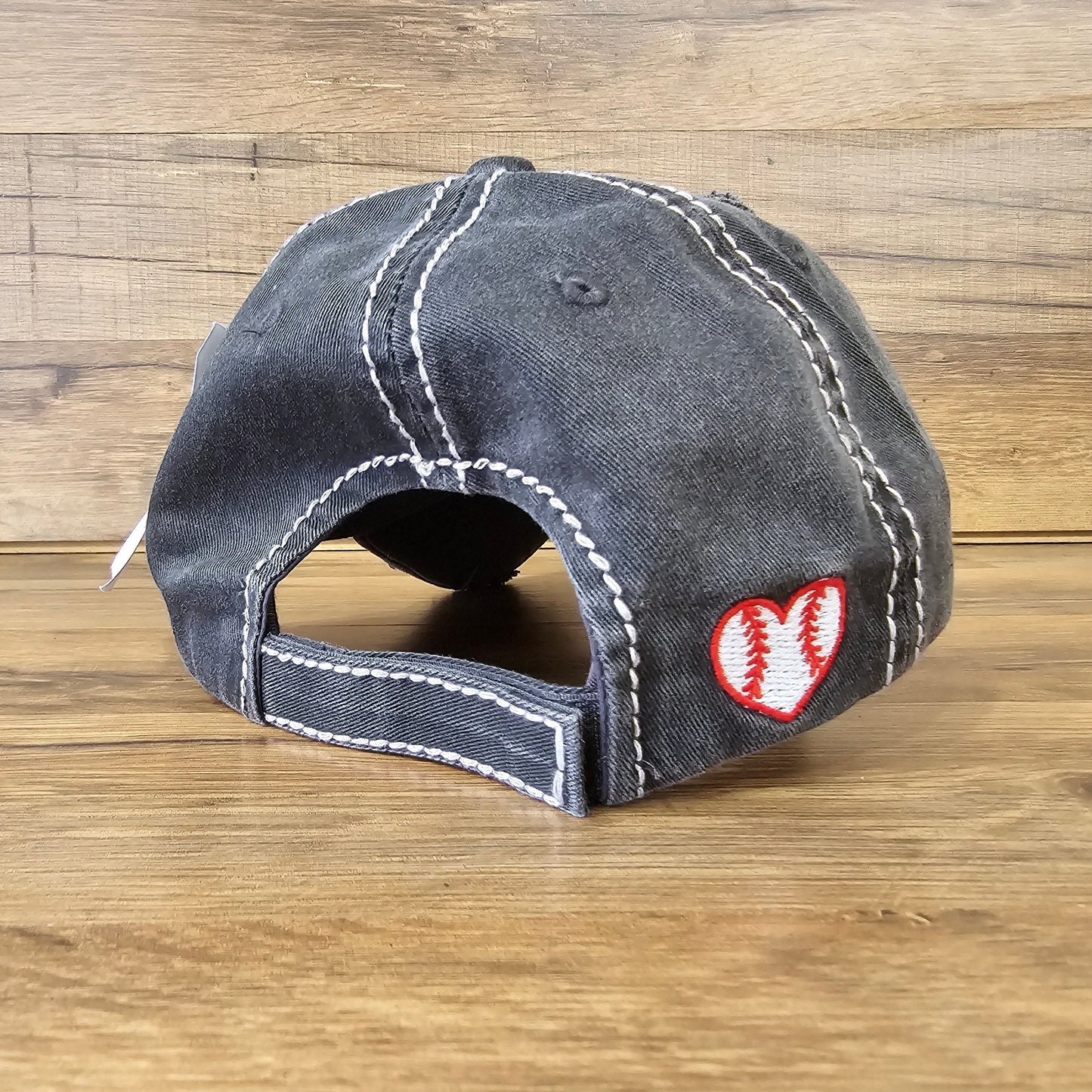 Allen's Bootery distressed black baseball cap with a white stitched heart and baseball seam embroidery on the back.