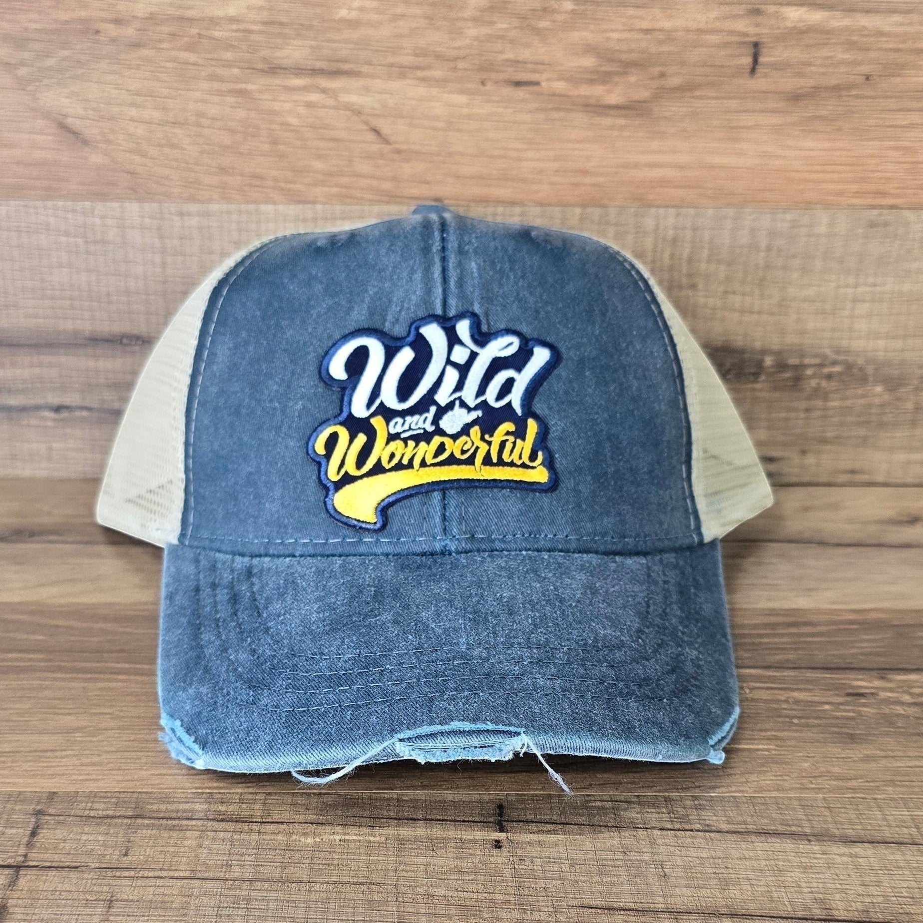 Allen's Bootery distressed blue denim trucker hat with a Wild & Wonderful embroidered patch and beige mesh back.