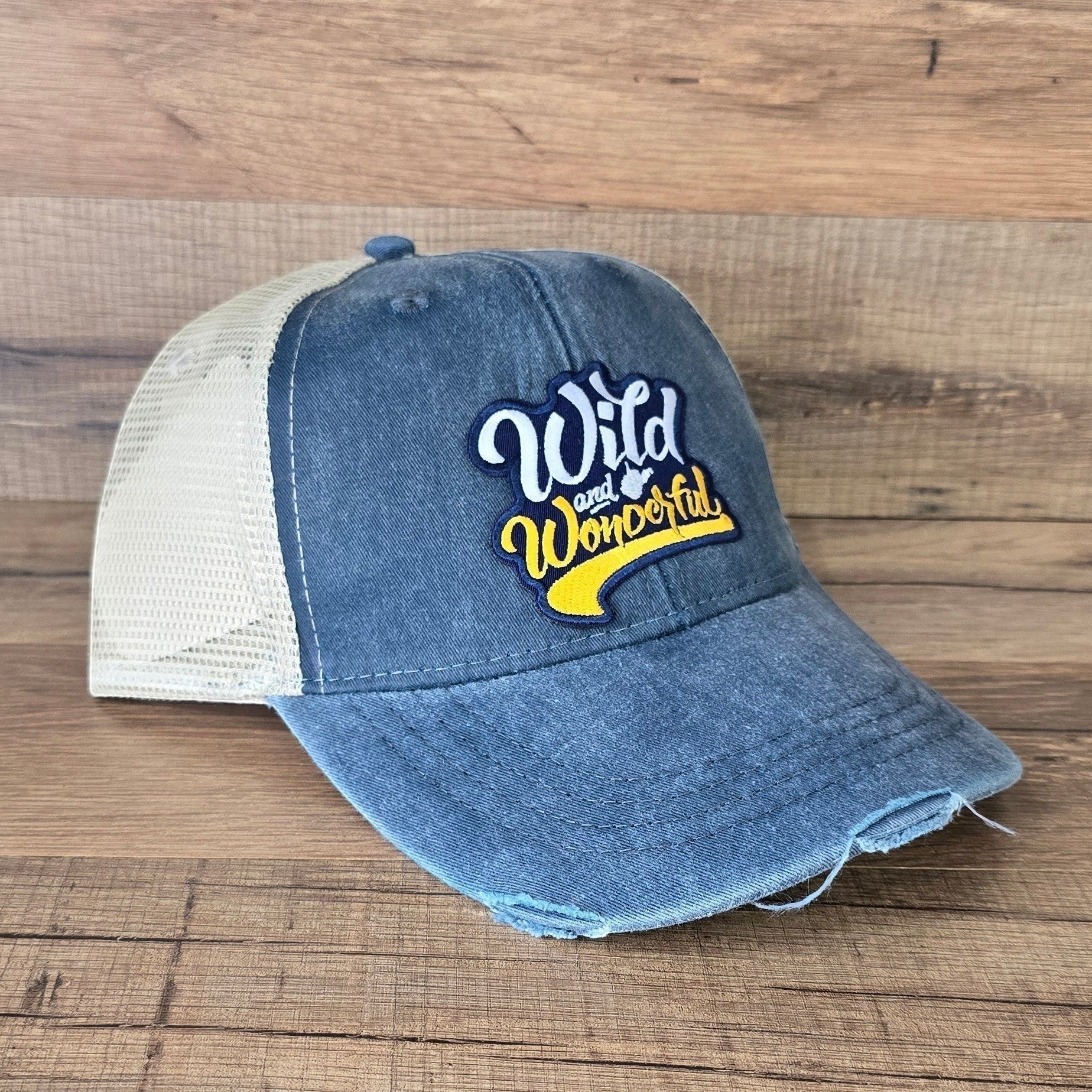 Allen's Bootery distressed blue denim trucker hat with a Wild & Wonderful embroidered patch and cream mesh back.