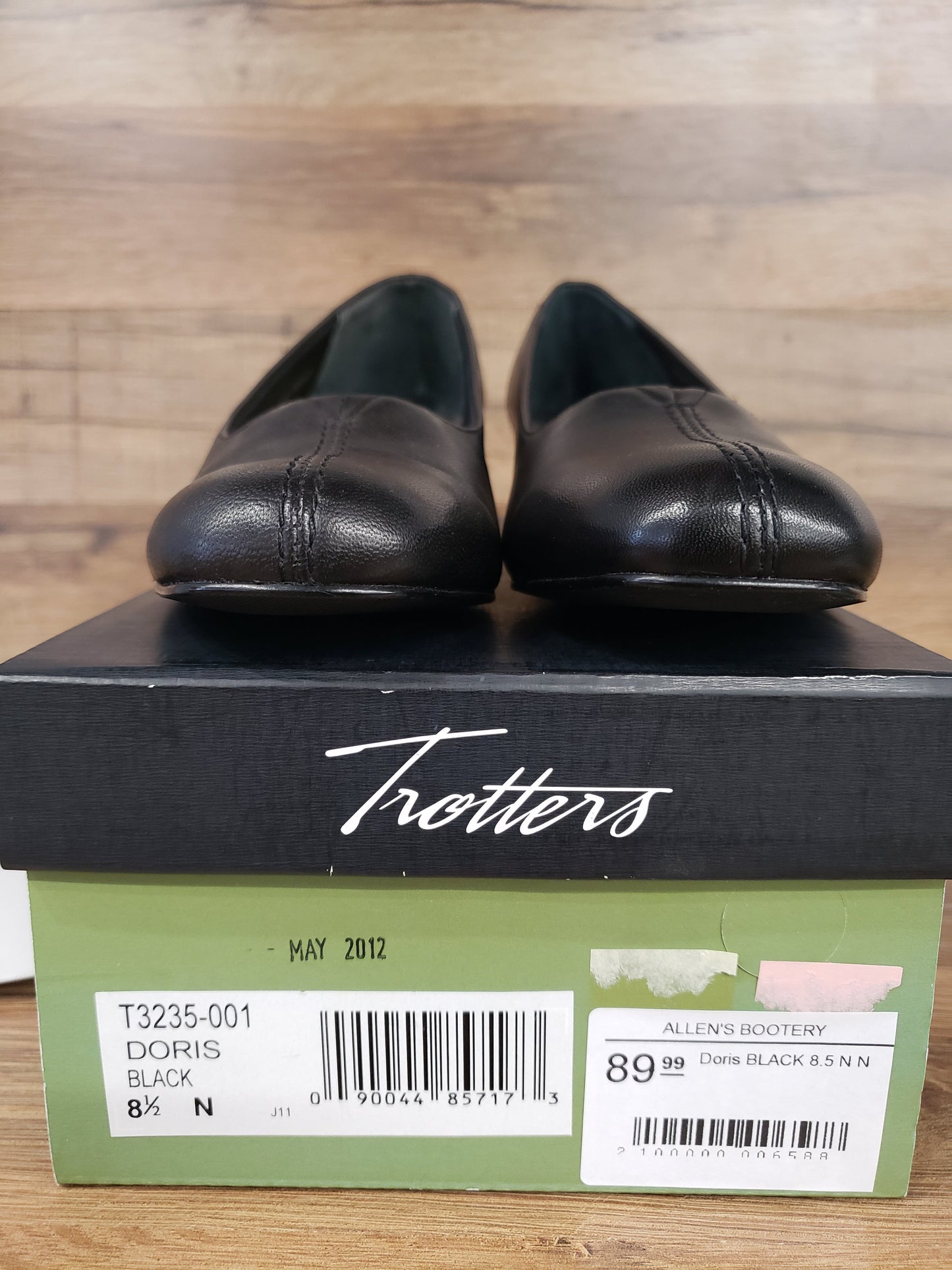 Allen's Bootery Doris black leather pumps with a rounded toe and center seam detail resting on their original shoe box.