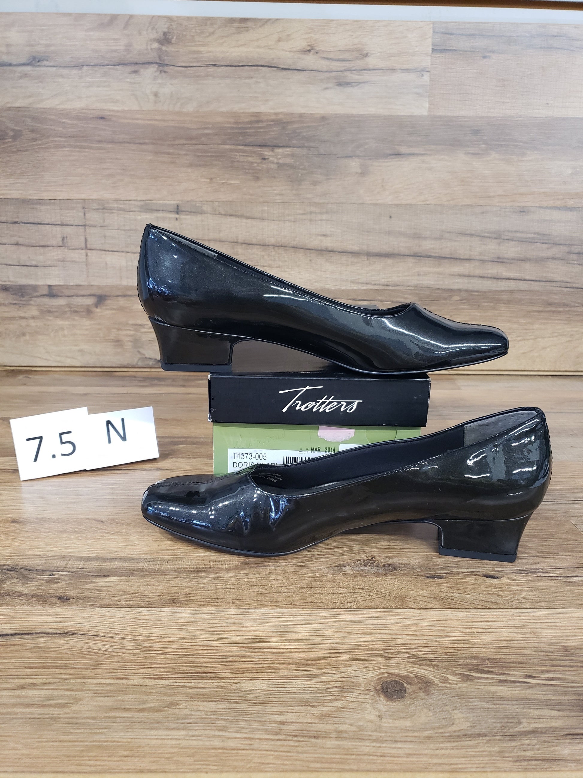 Allen's Bootery Doris black patent leather low heel pumps with a v-gore center vamp and synthetic rubber sole.