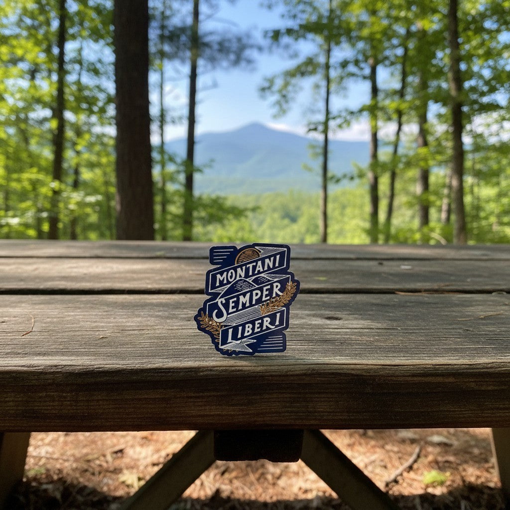 Allen's Bootery Montani Semper Liberi weather-resistant sticker featuring mountain and wheat design on a picnic table