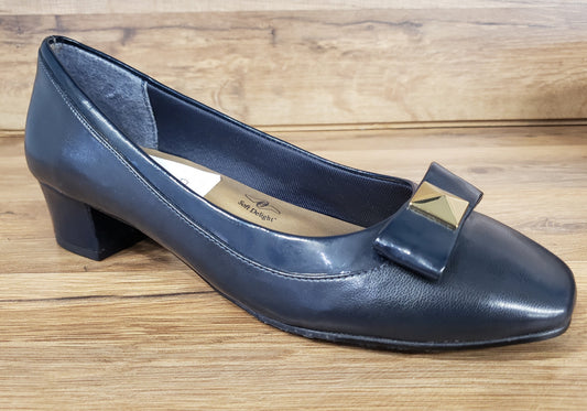 Allen's Bootery navy blue cap toe pump with a decorative bow and gold metal ornament on a low block heel