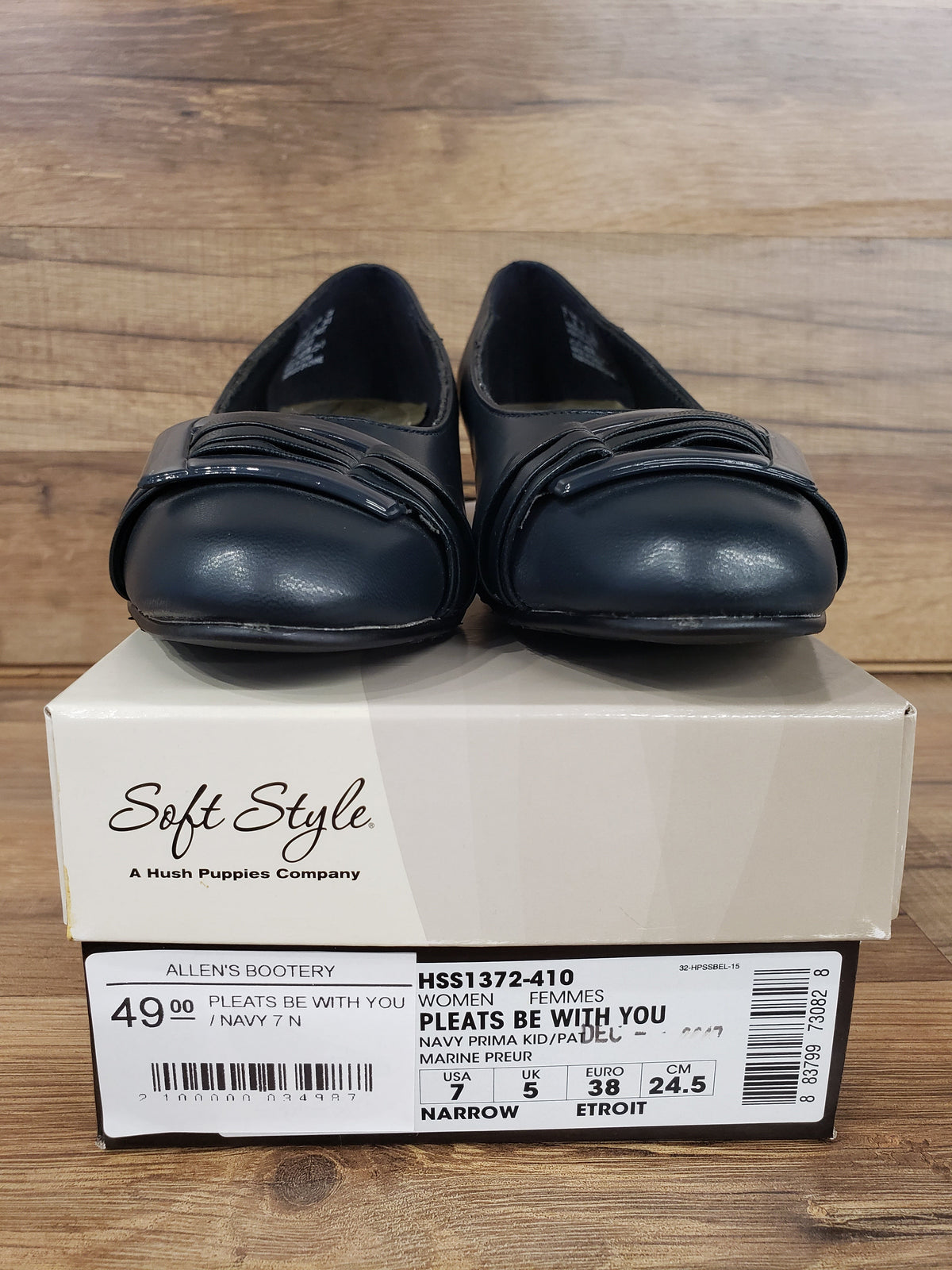 Allen's Bootery navy blue closed-toe pumps with pleated toe detail and buckle, featuring a low heel and memory foam.