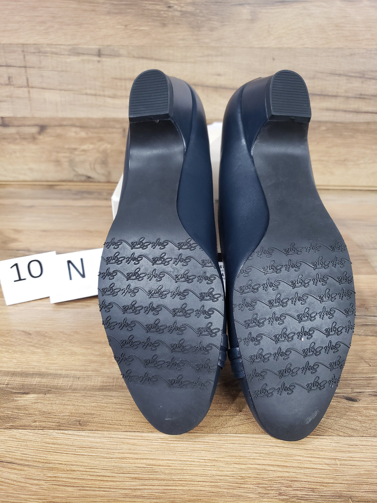 Allen's Bootery navy blue closed-toe pumps showing the molded rubber outsoles with traction pattern