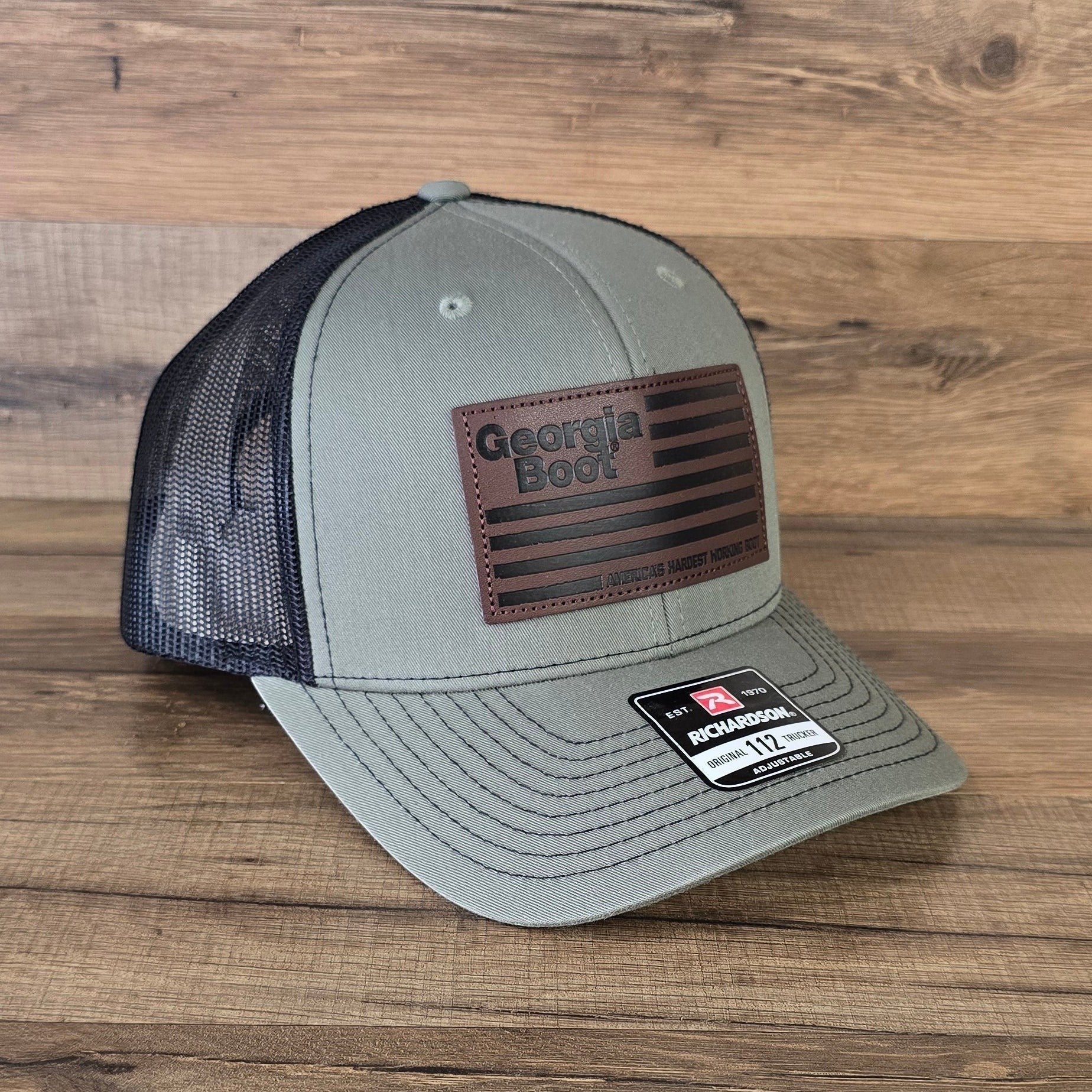 Allen's Bootery olive green and black mesh trucker hat with a square leather Georgia Boot flag patch.