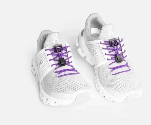 Allen's Bootery Xpand Laces purple elastic quick-release system installed on white athletic sneakers