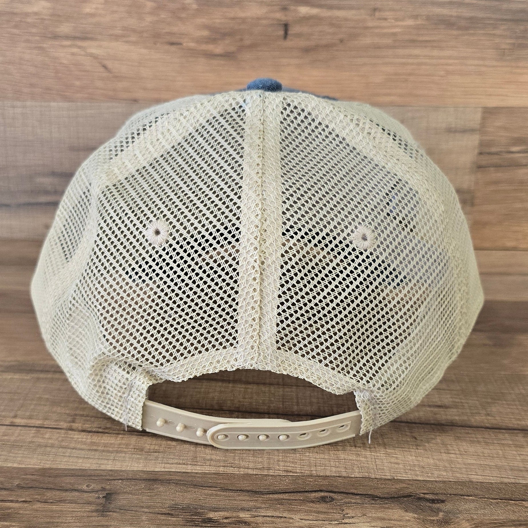 Allen's Bootery Mountain Mama trucker hat featuring a beige breathable mesh back and adjustable snapback closure
