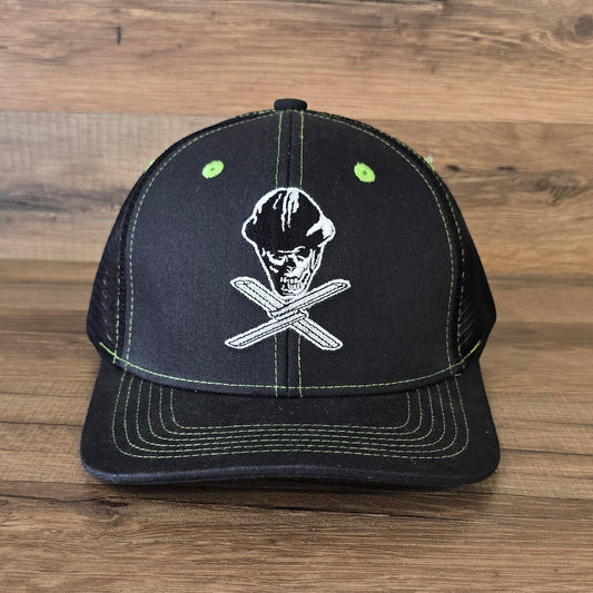 Allen's Bootery Twisted X black mesh hat featuring a white skull and cross-tool embroidery with lime green stitching.