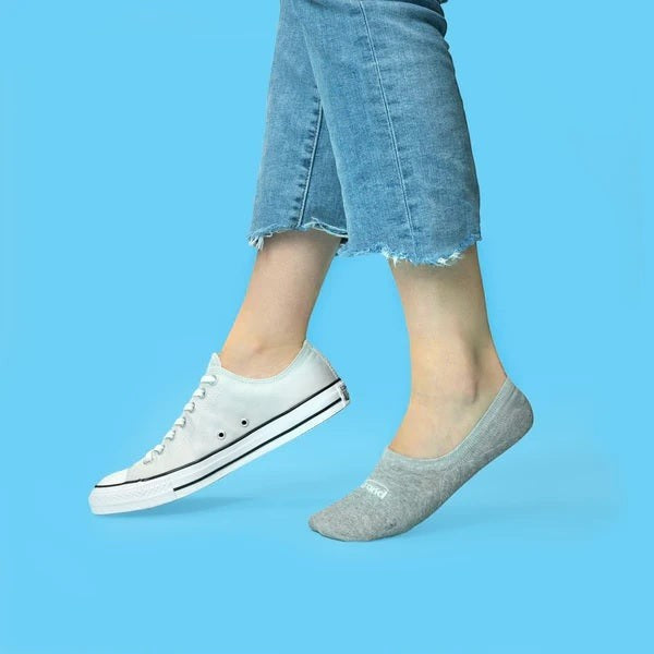 Allen's Bootery Xpand lightweight grey no-show socks with anti-slip heel lock worn with a white sneaker.