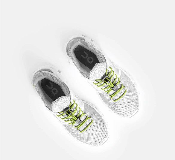 Allen's Bootery Xpand Laces in lemon lime installed on white running shoes for a secure, no-tie fit.