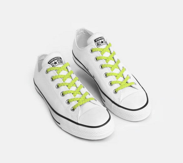 Allen's Bootery Xpand Laces in lemon lime reflective installed on white low-top sneakers for a secure slip-on fit.