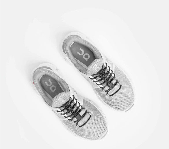 Allen's Bootery Xpand Laces quick release black reflective elastic laces installed on grey athletic sneakers