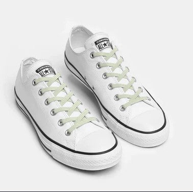 Allen's Bootery Xpand off-white elastic no-tie laces installed on white low-top sneakers for a slip-on fit.