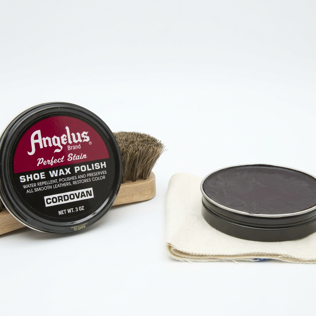 Allen's Bootery Angelus Cordovan shoe wax polish tin with applicator brush and polishing cloth on white background