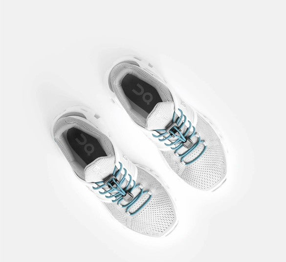 Allen's Bootery baby blue Xpand quick release elastic laces installed on white athletic sneakers