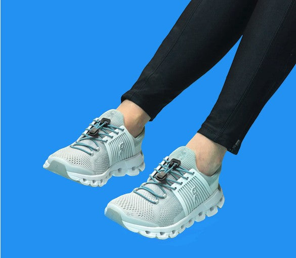 Allen's Bootery baby blue Xpand quick release elastic laces installed on light grey athletic sneakers