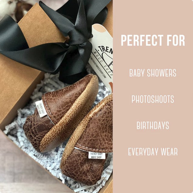 Allen's Bootery brown leather soft sole infant moccasins in a gift box with black ribbon