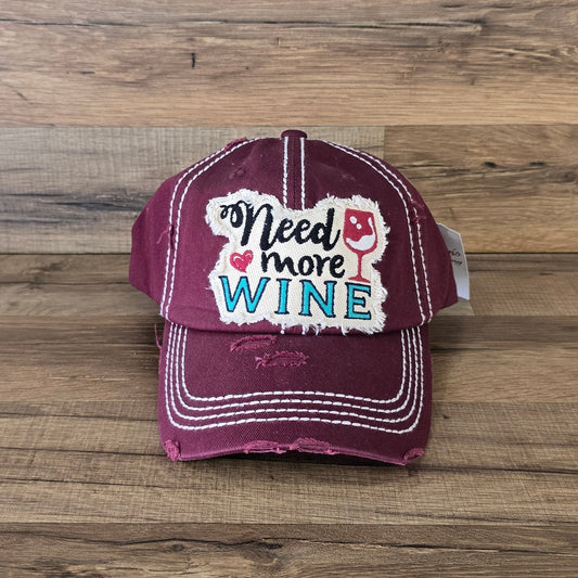Allen's Bootery burgundy distressed cotton baseball cap with Need More Wine embroidered patch and white stitching