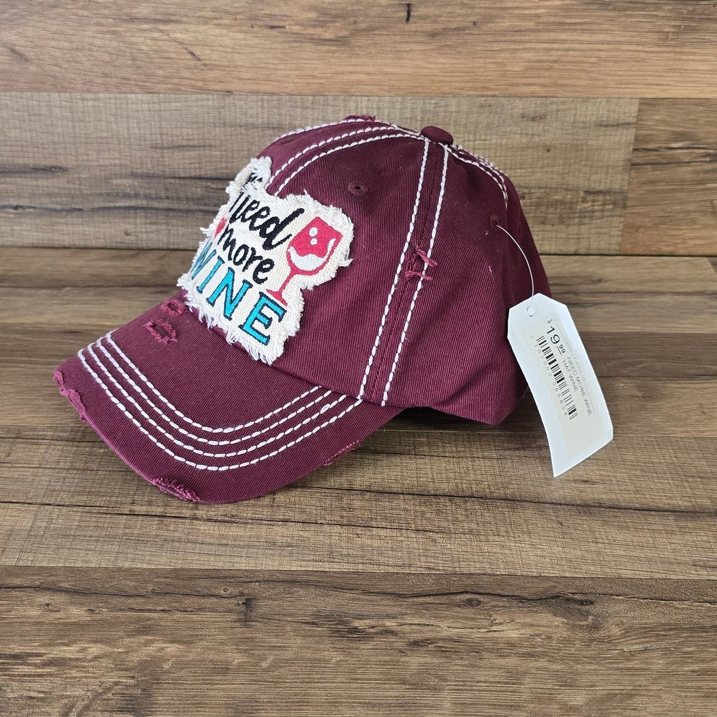 Allen's Bootery burgundy distressed cotton baseball cap with Need More Wine embroidered patch and white stitching