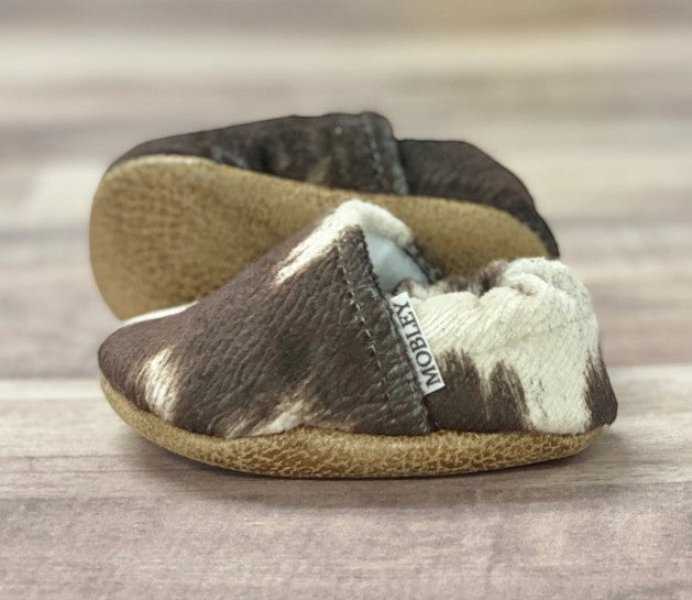 Allen's Bootery infant moccasins in brown and white cowhide print leather with soft soles for babies