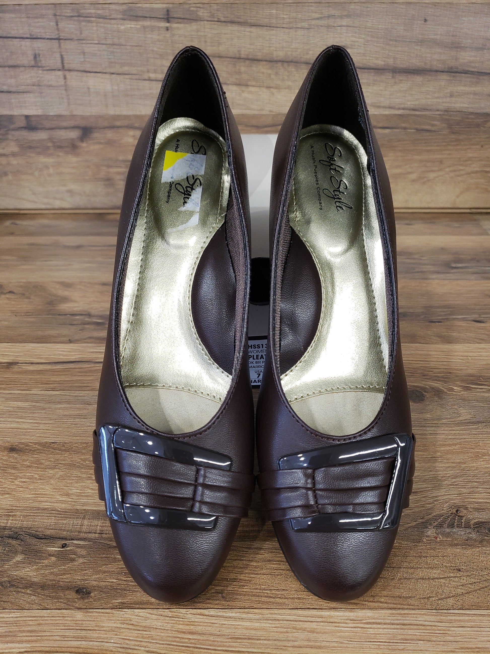 Allen's Bootery dark brown closed-toe pumps with pleated toe detail, buckle ornament, and memory foam footbed.