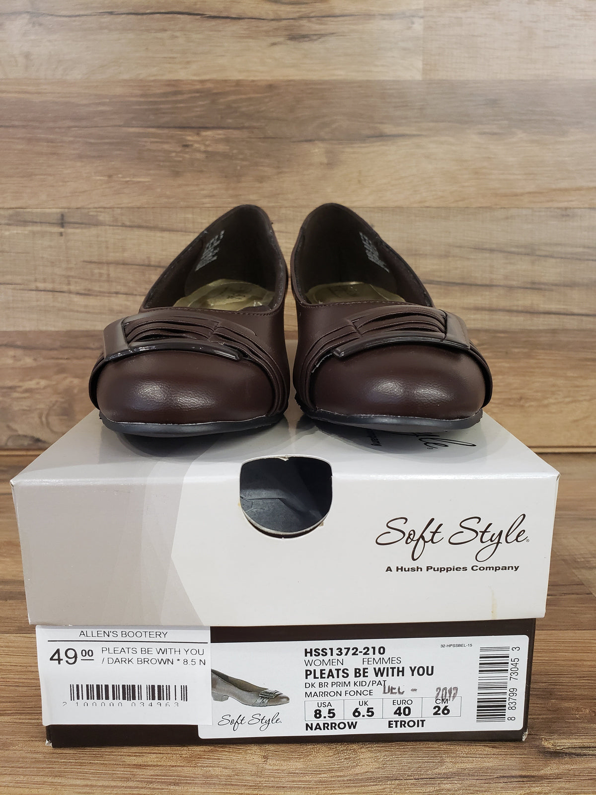 Allen's Bootery dark brown Pleats Be With You pumps with pleated toe detail and buckle on a branded shoe box.