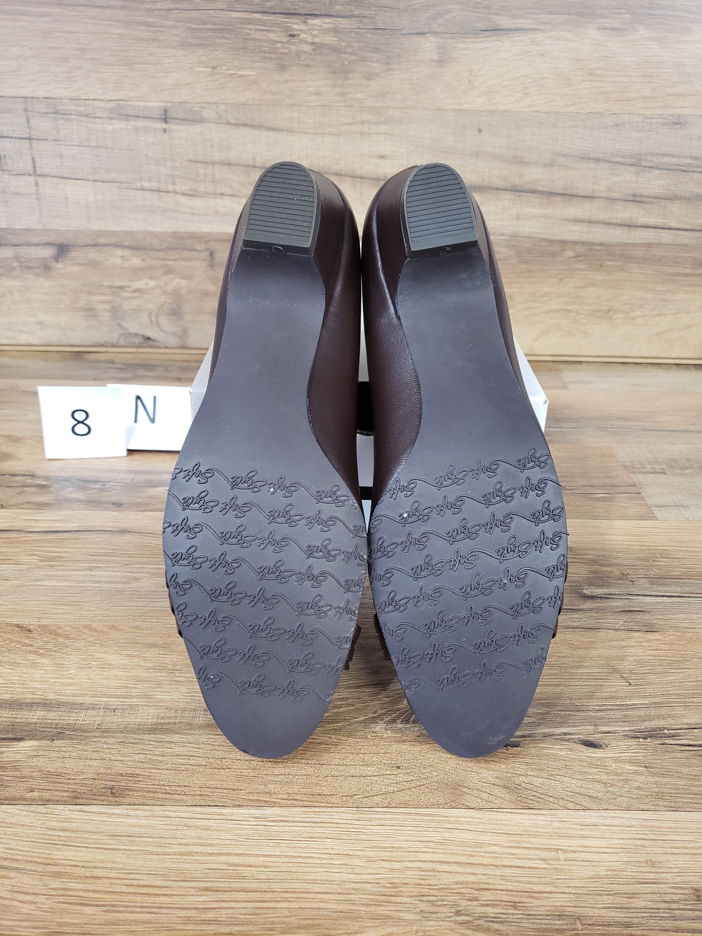 Allen's Bootery Pleats Be With You dark brown pumps showing the molded rubber outsoles with traction pattern