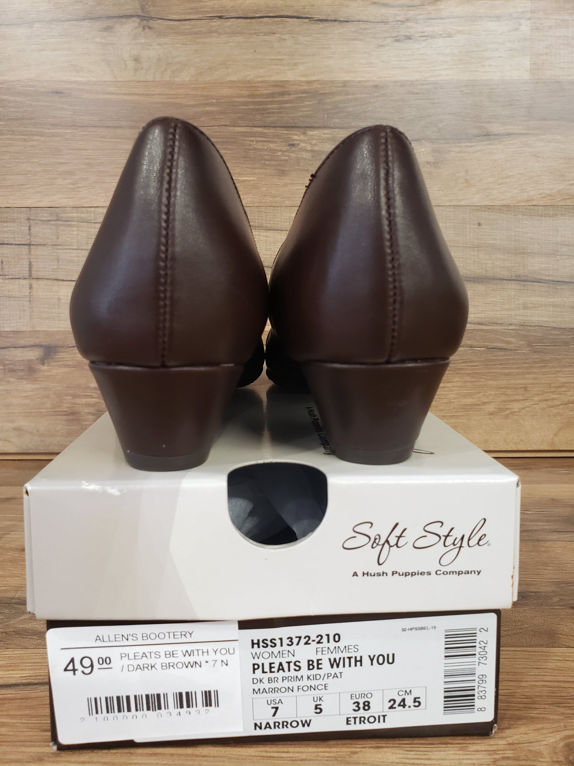 Allen's Bootery dark brown Pleats Be With You pumps viewed from the back, resting on their original shoe box.