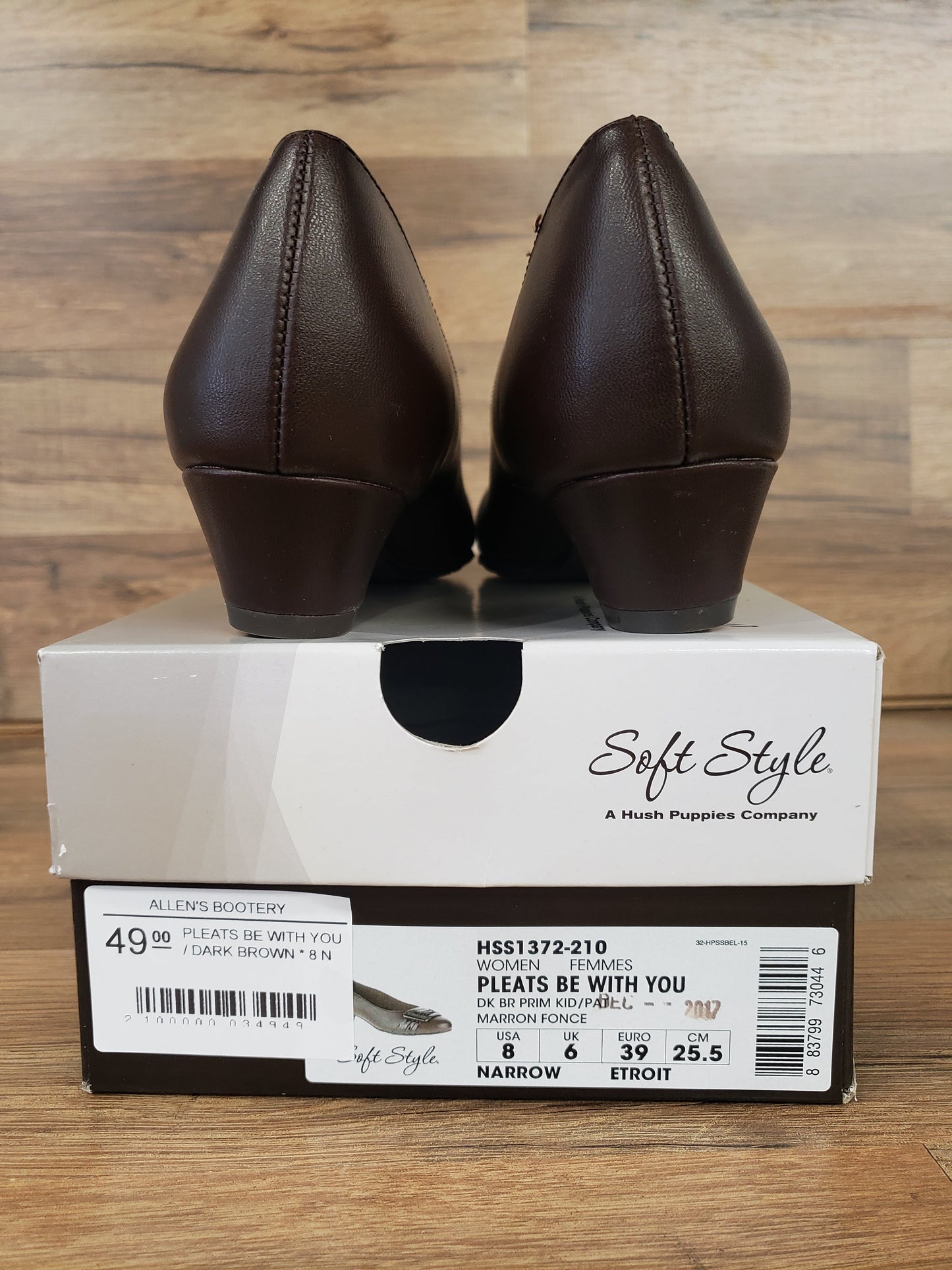 Allen's Bootery dark brown Pleats Be With You pumps viewed from the back, resting on their original shoe box.