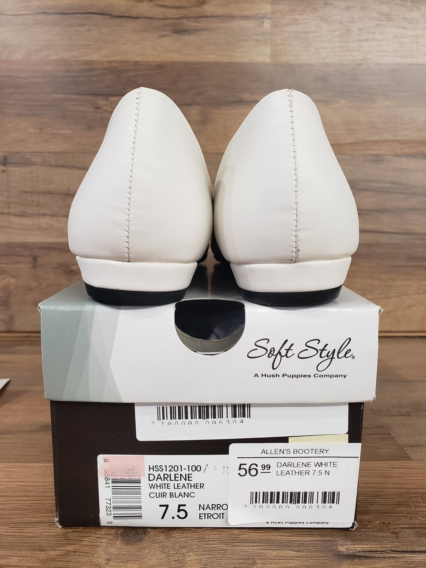 Allen's Bootery Darlene white leather flats viewed from the back, resting on their original Soft Style shoe box.