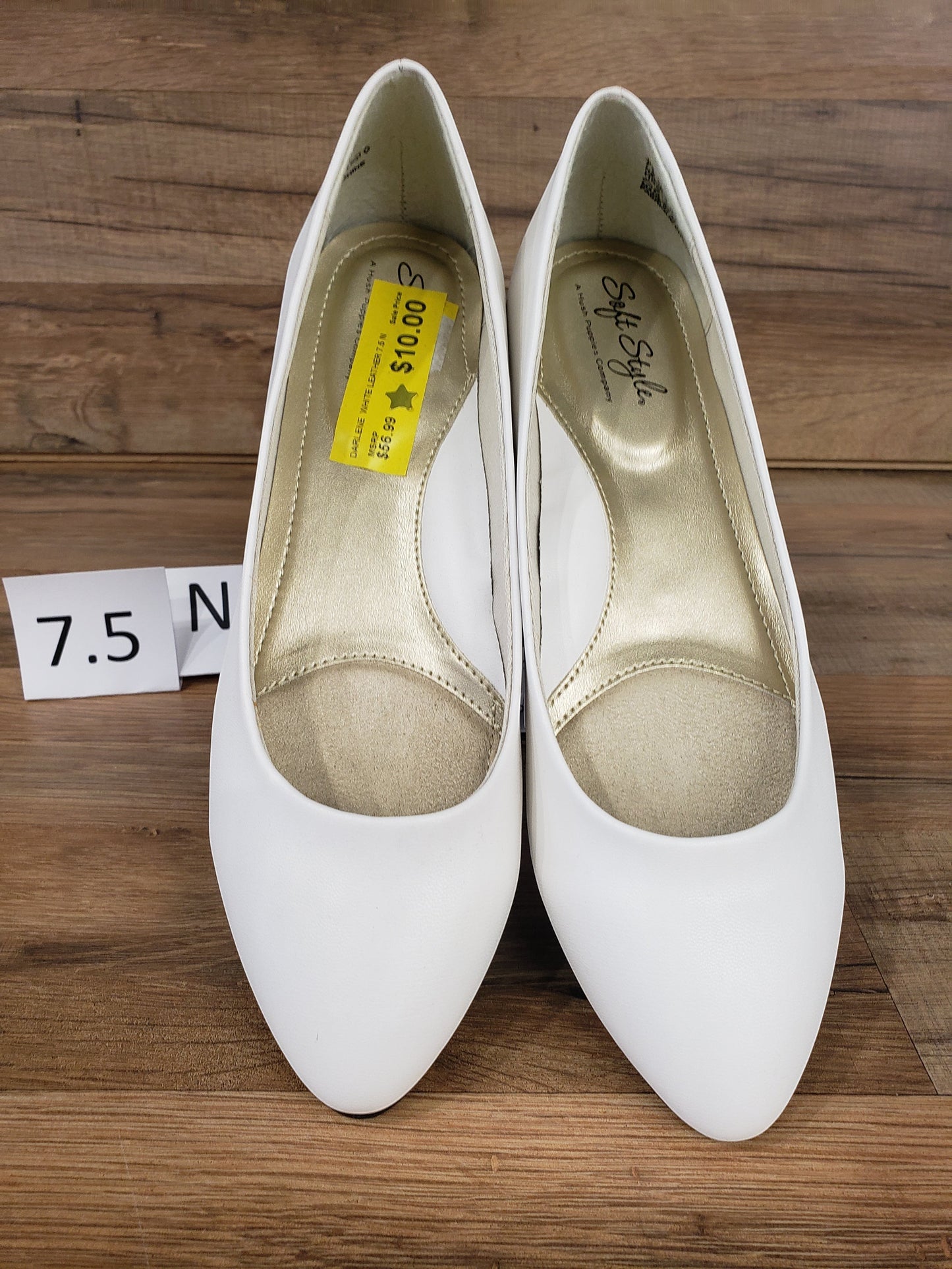 Allen's Bootery Darlene white leather pumps with low heels and cushioned insoles on a wooden background