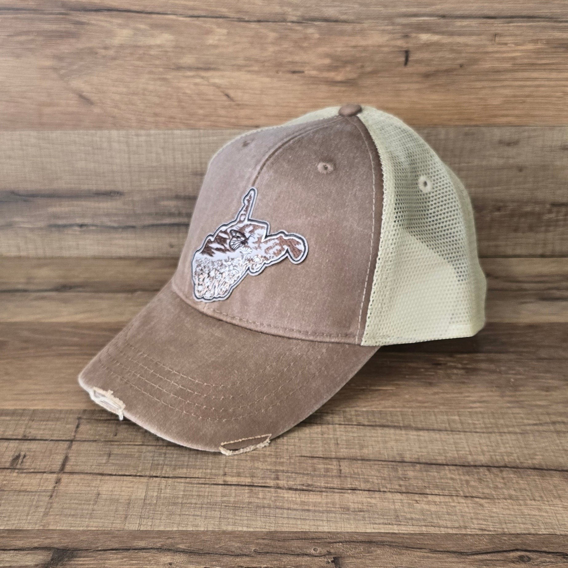 Allen's Bootery distressed brown trucker hat with a mesh back and a Monarch butterfly state-shaped patch.