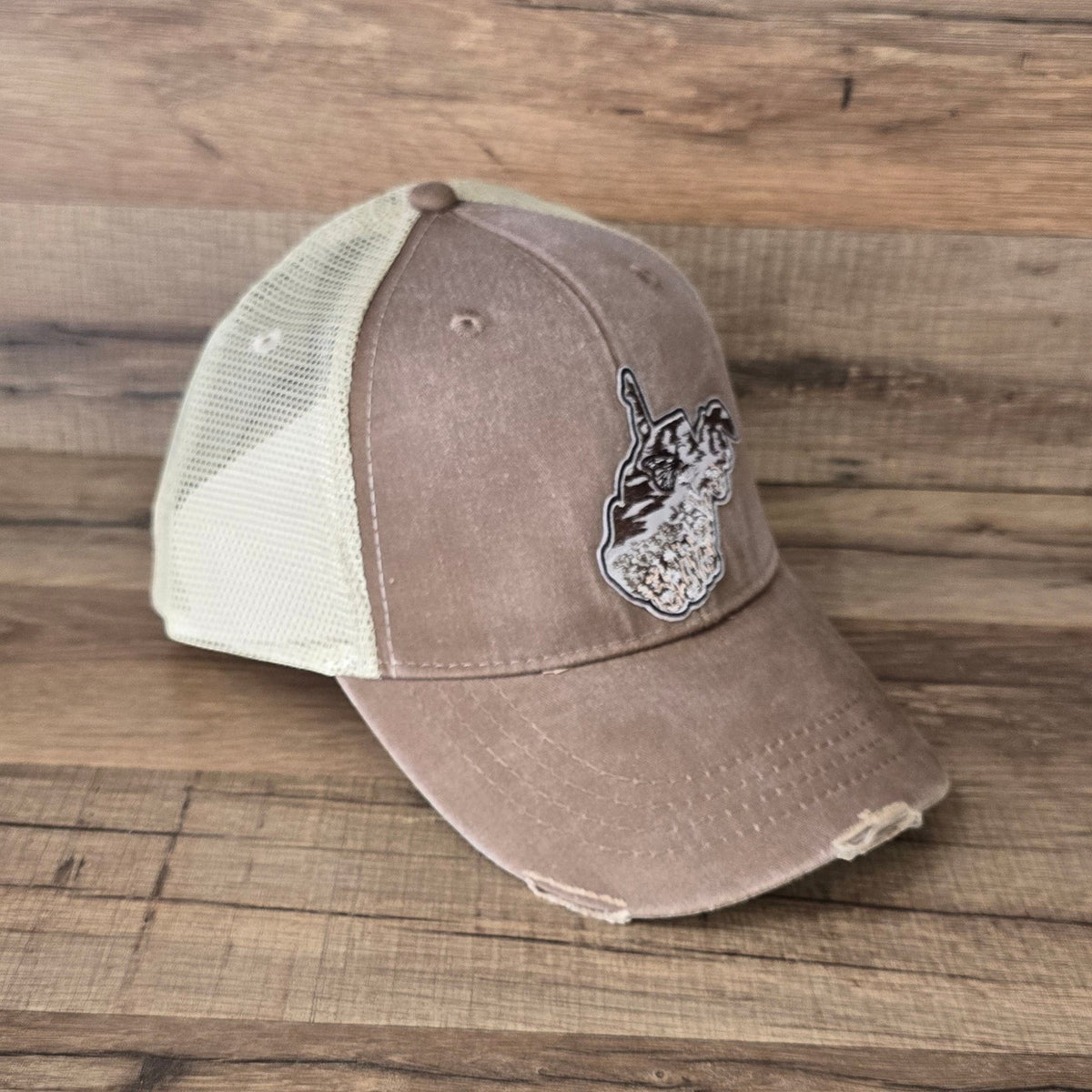 Allen's Bootery distressed brown trucker hat with a cream mesh back and monarch butterfly patch on the front.