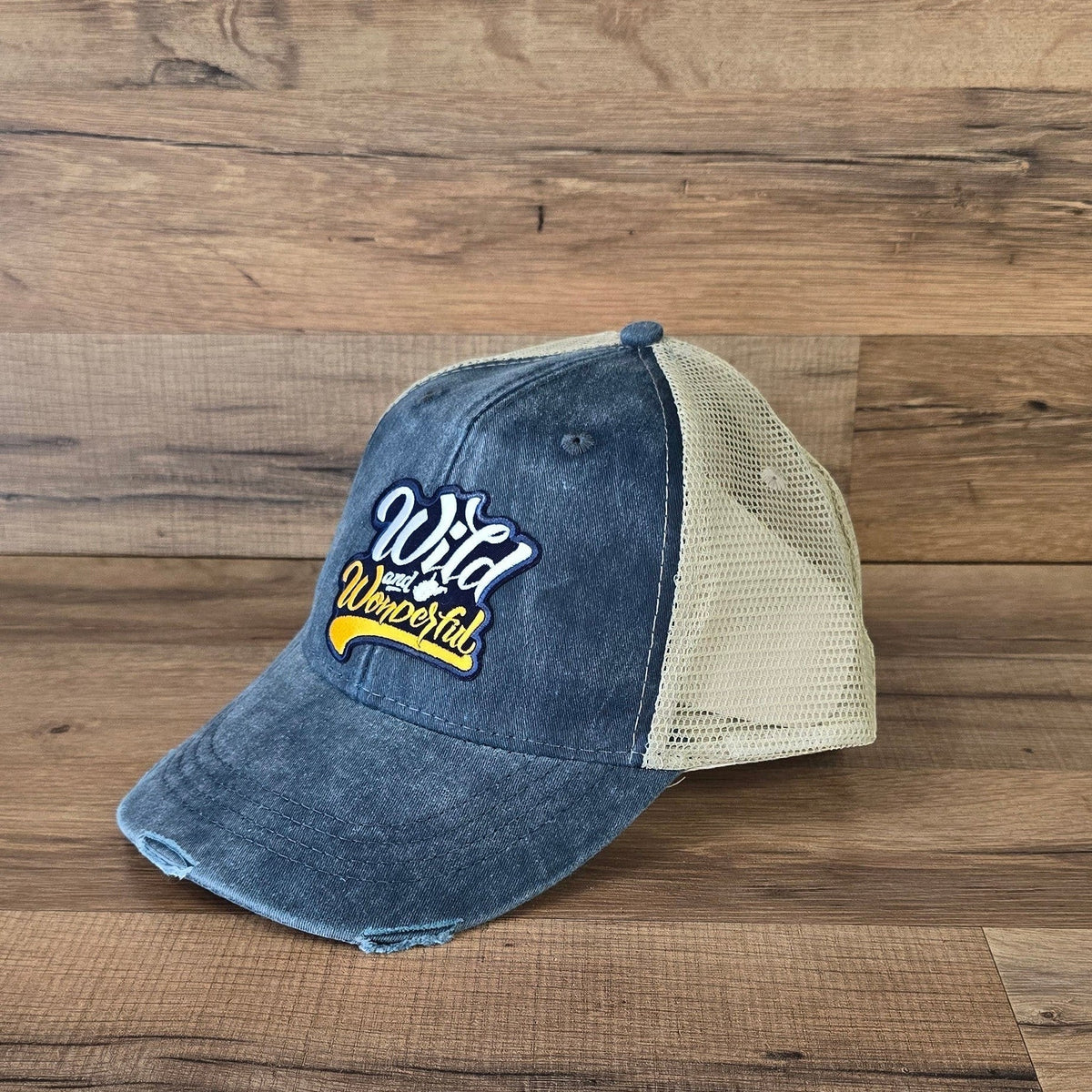 Allen's Bootery distressed denim trucker hat with a beige mesh back and Wild & Wonderful embroidered patch.