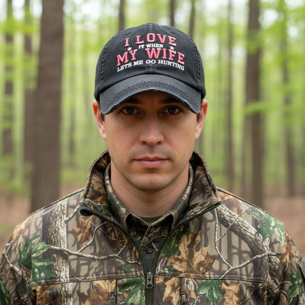 Allen's Bootery black distressed baseball cap with red and white embroidered text worn by a man in a forest