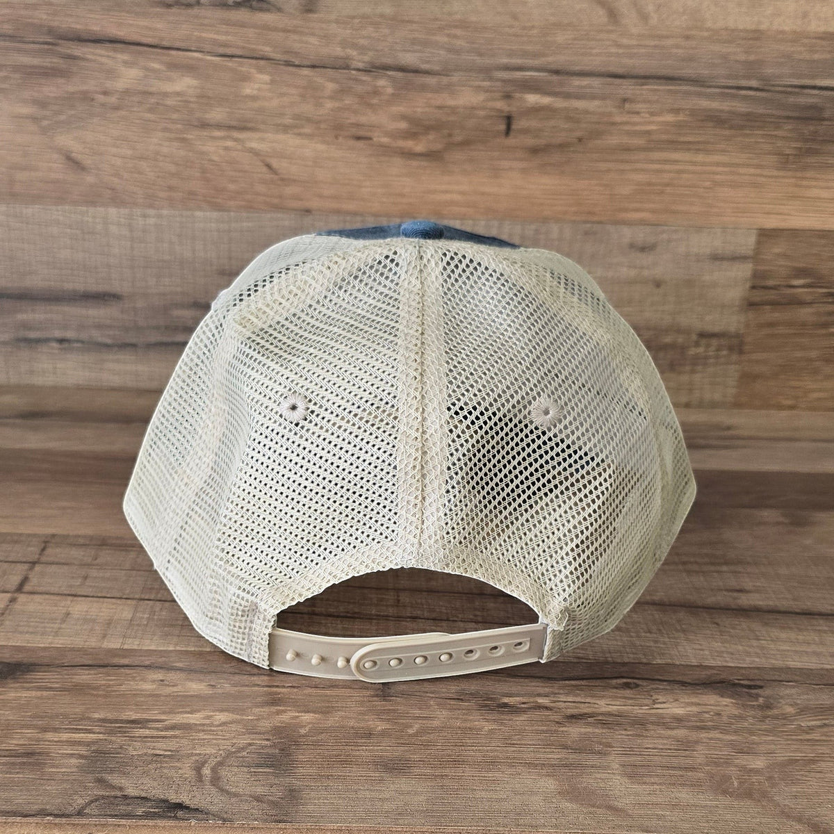 Allen's Bootery distressed trucker hat featuring a beige mesh back and adjustable snapback closure