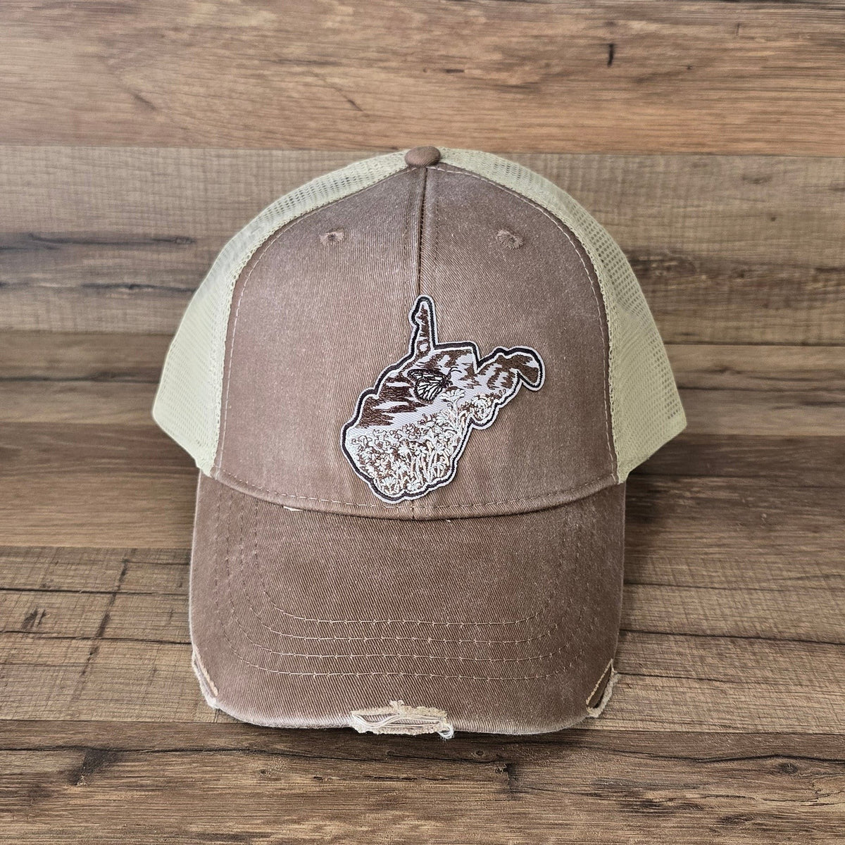 Allen's Bootery distressed brown trucker hat with a mesh back and a West Virginia monarch butterfly patch.