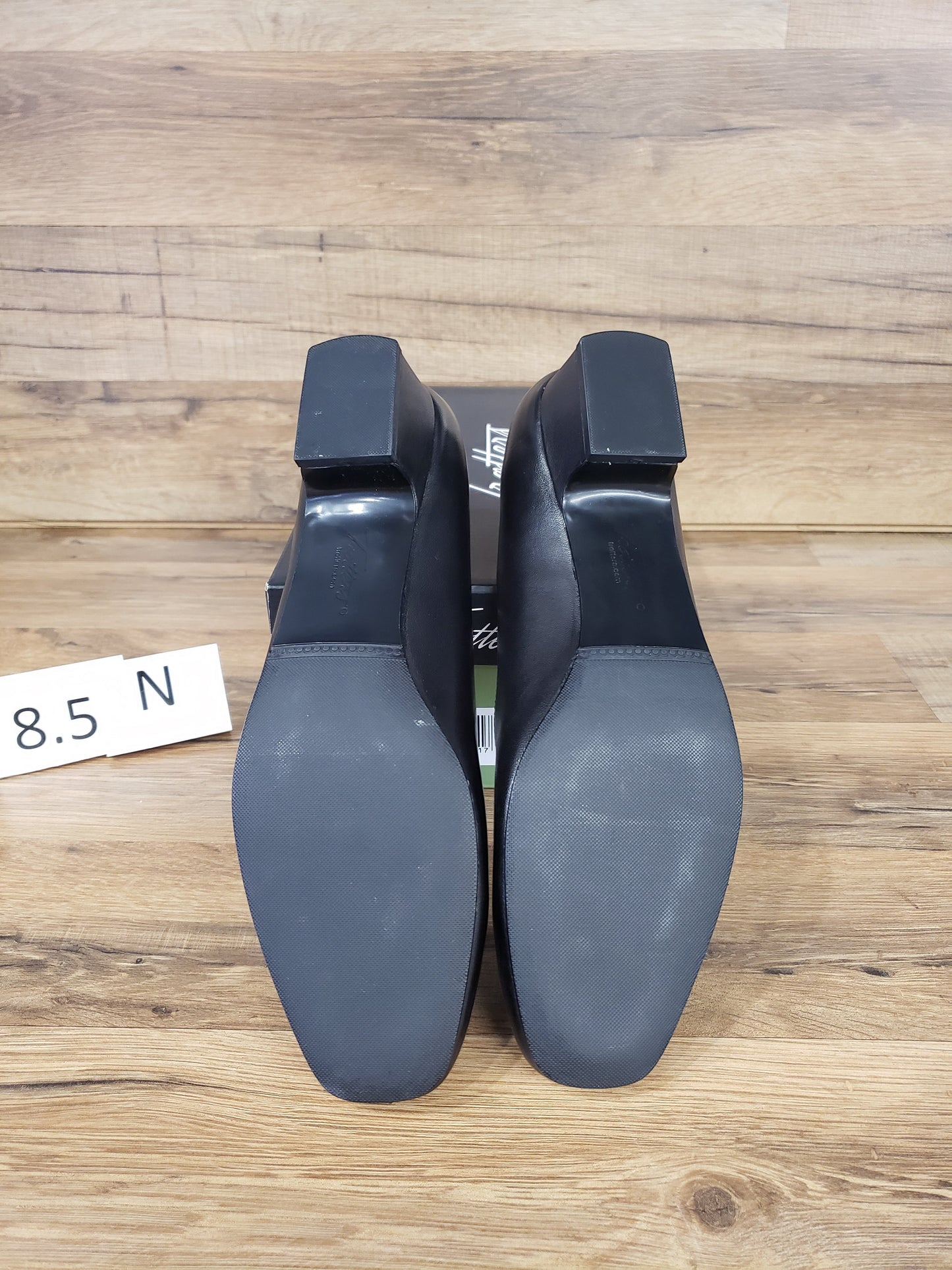 Allen's Bootery Doris black leather pumps showing the synthetic rubber soles and low block heels from below