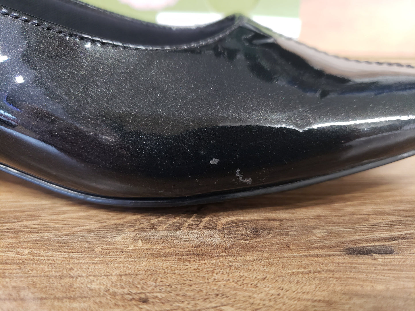 Allen's Bootery Doris black pearl patent leather pump showing a small surface blemish on the side