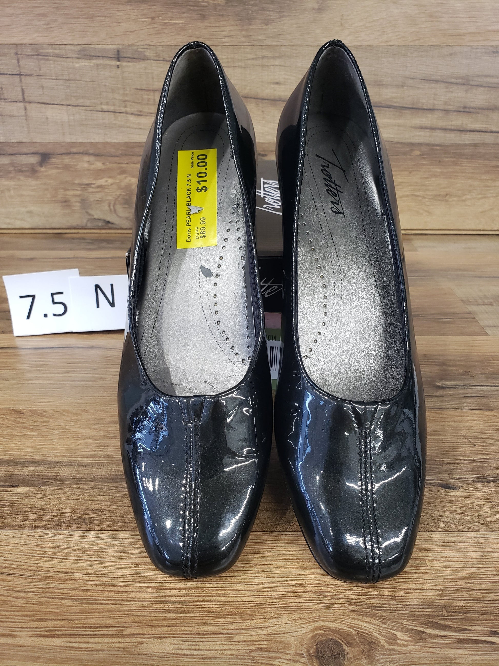 Allen's Bootery Doris black pearl patent leather pumps with a low heel and v-gore center vamp detail.