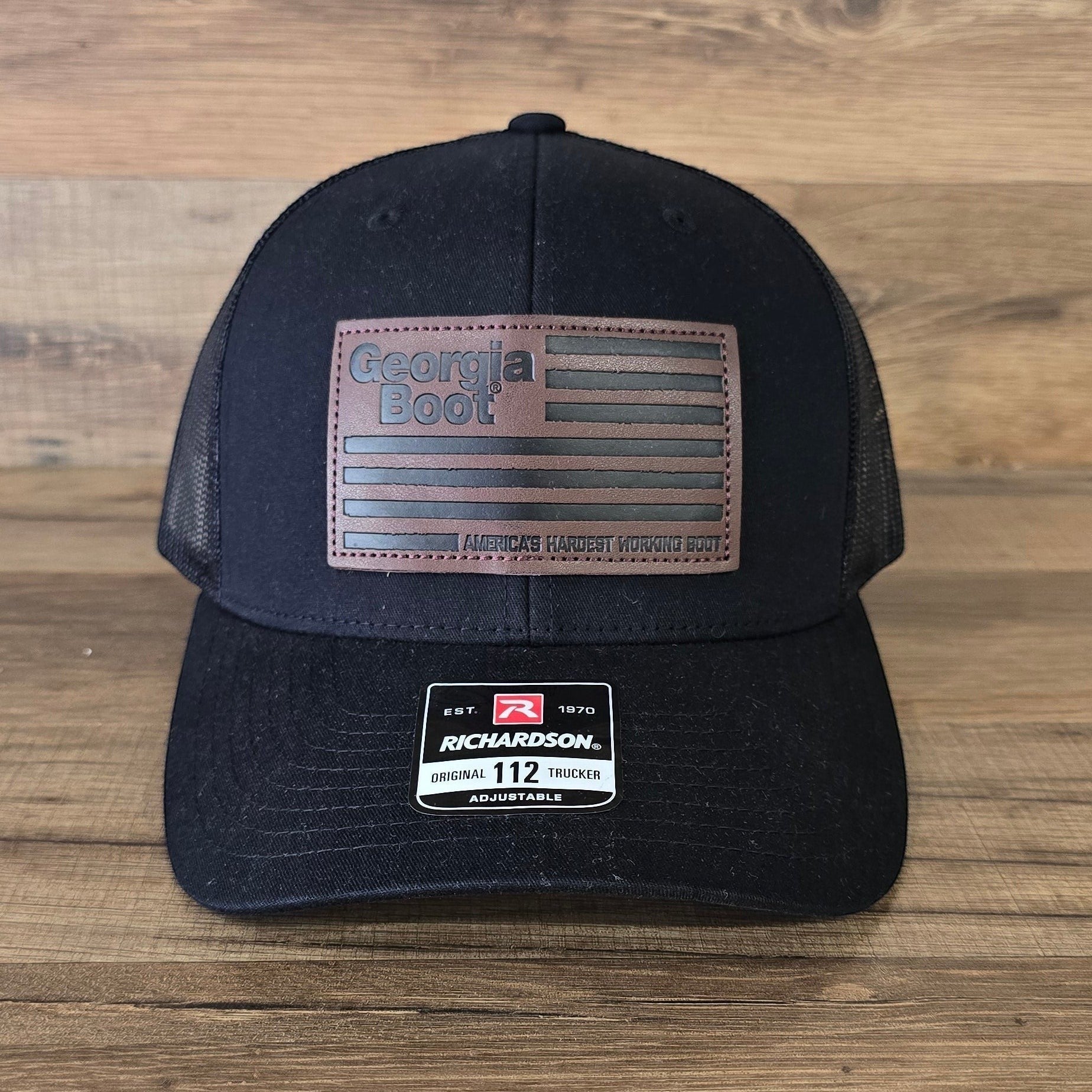 Allen's Bootery black Georgia Boot trucker hat with a brown leather flag patch and mesh back